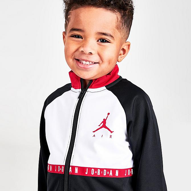 On Model 5 view of Boys' Toddler Jordan Air Blocked Tricot Track Jacket and Jogger Pants Set in Black/White/Red Click to zoom