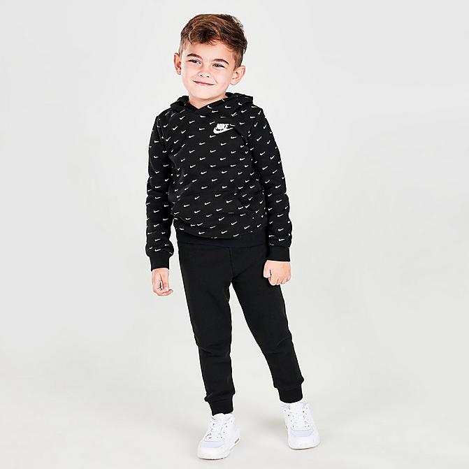 Front view of Kids' Toddler Nike Allover Print Swoosh Hoodie and Jogger Pants Set in Black/White Click to zoom