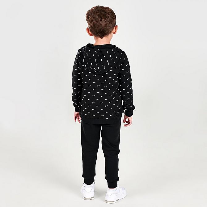 Front Three Quarter view of Kids' Toddler Nike Allover Print Swoosh Hoodie and Jogger Pants Set in Black/White Click to zoom