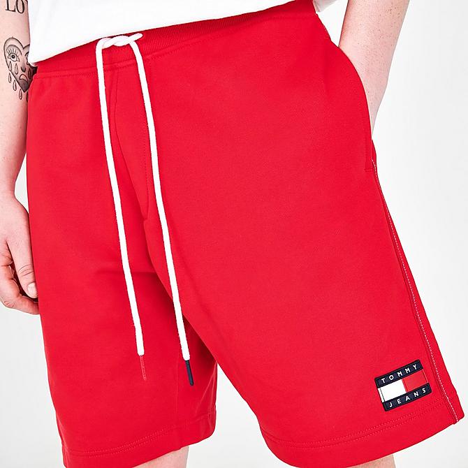 On Model 5 view of Men's Tommy Jeans Drawstring Fleece Shorts in Blush Red Click to zoom