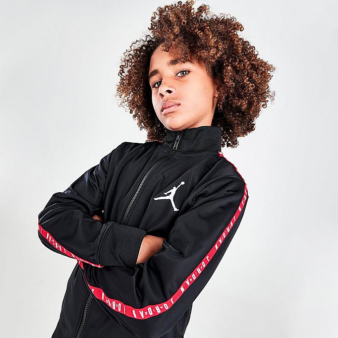 On Model 5 view of Boys' Jordan Tape Track Suit in Black/Red Click to zoom