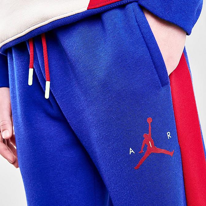 On Model 5 view of Boys' Jordan Wild Utility Jogger Pants in Racer Blue/Pearl White/Gym Red Click to zoom
