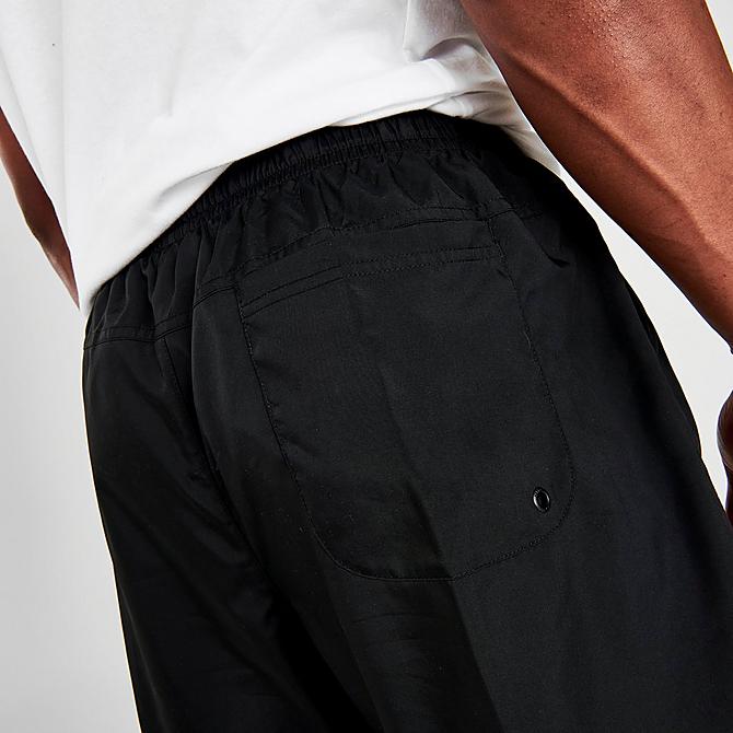 On Model 6 view of Men's Nike Sportswear Flow Woven Shorts in Black/White Click to zoom