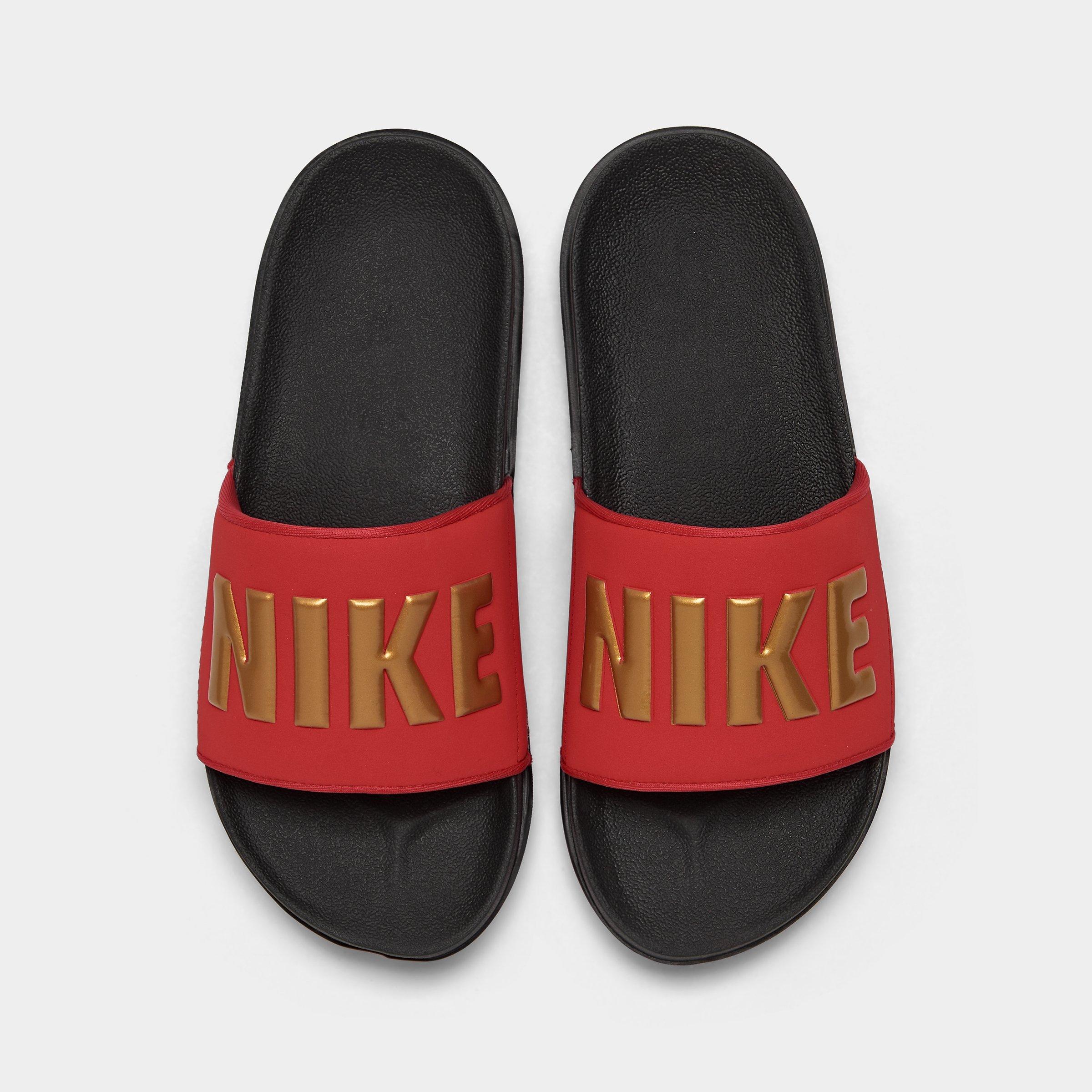 black red and gold nike slides