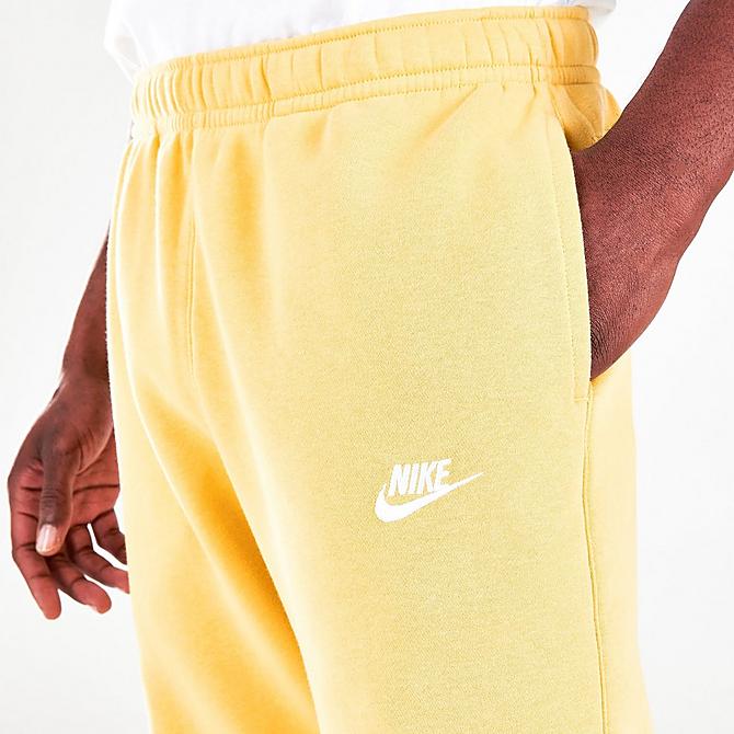On Model 5 view of Nike Sportswear Club Fleece Cuffed Jogger Pants in Saturn Gold/Saturn Gold/White Click to zoom