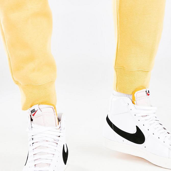 On Model 6 view of Nike Sportswear Club Fleece Cuffed Jogger Pants in Saturn Gold/Saturn Gold/White Click to zoom