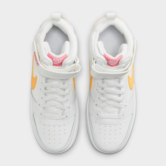 coral color nike shoes