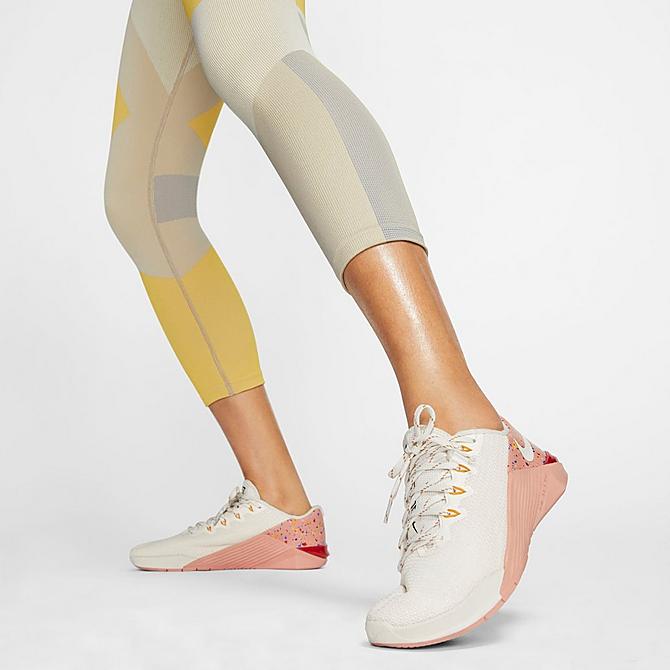 On Model 5 view of Women's Nike Sculpt Icon Clash Crop Running Tights in Pale Ivory/Shimmer/Laser Orange/Pale Ivory Click to zoom