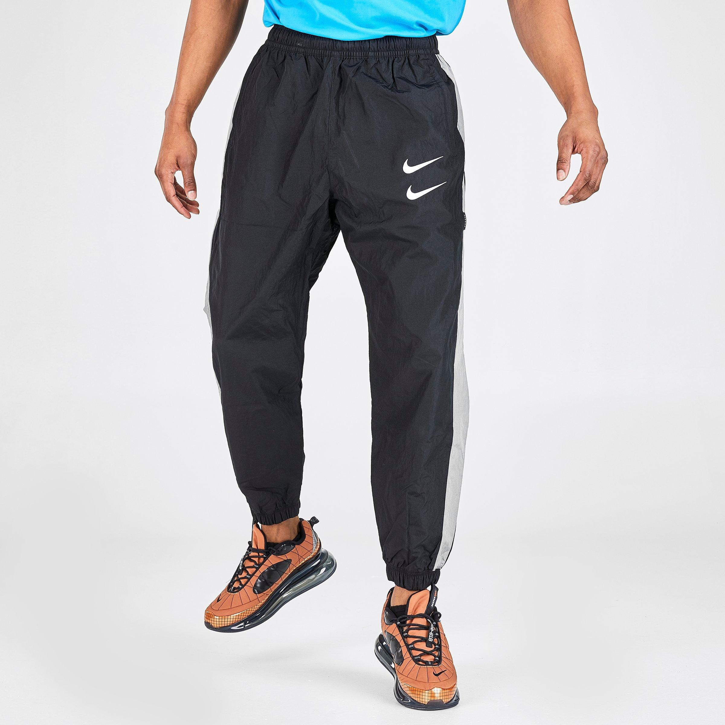 nike black swoosh woven joggers