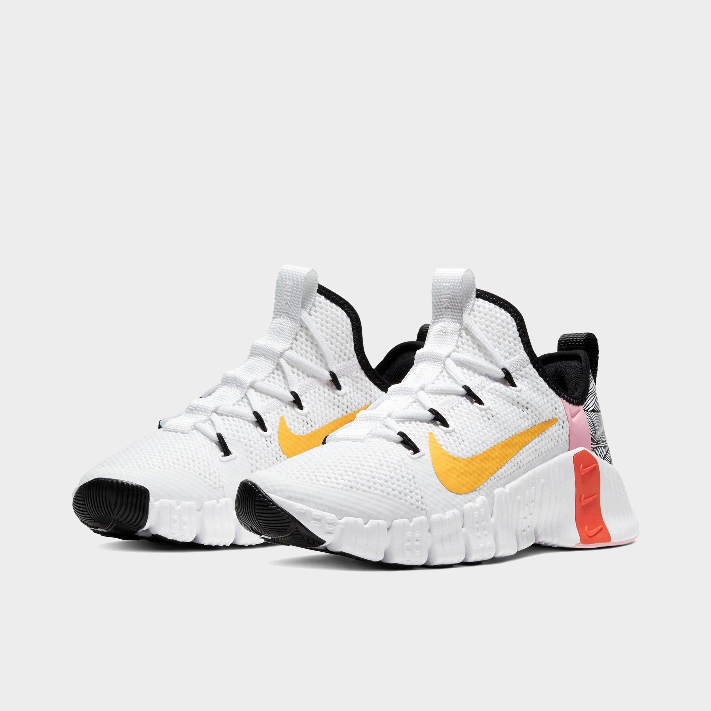 nike training metcon sneakers in white and orange