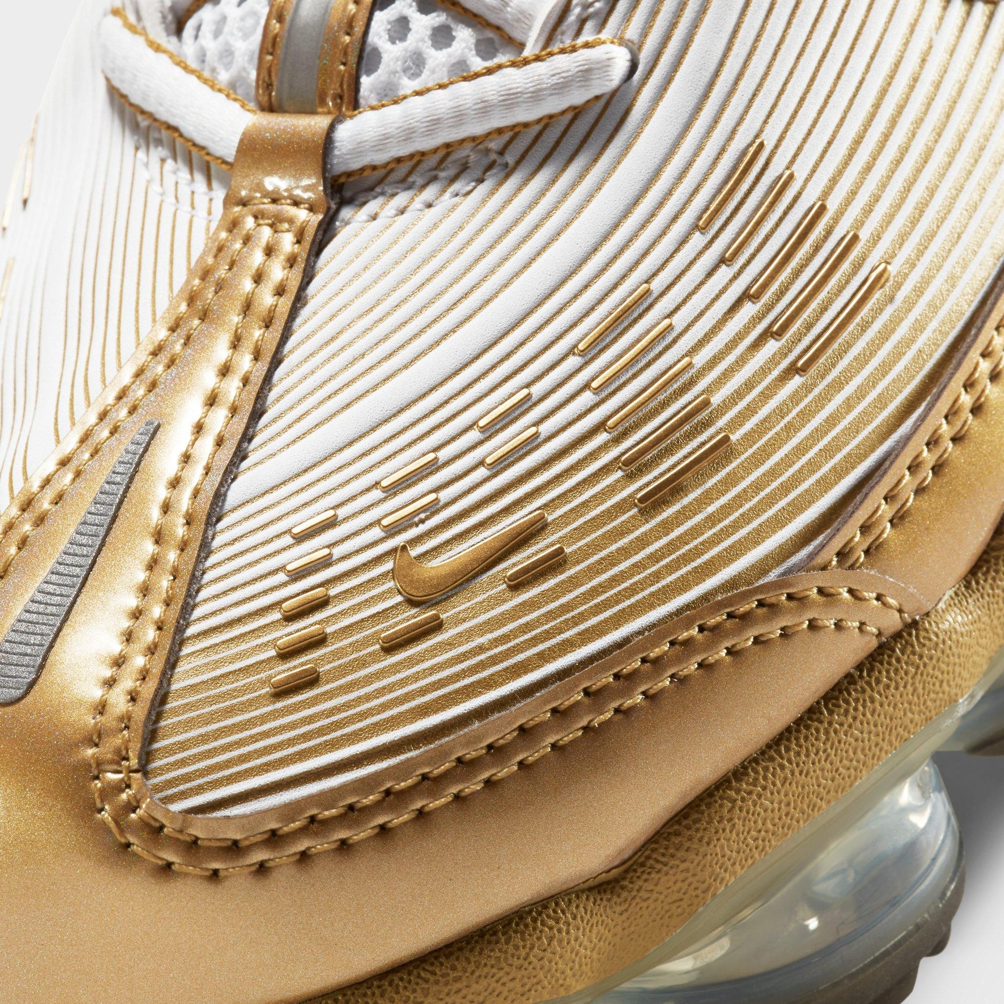 white and gold nike running shoes