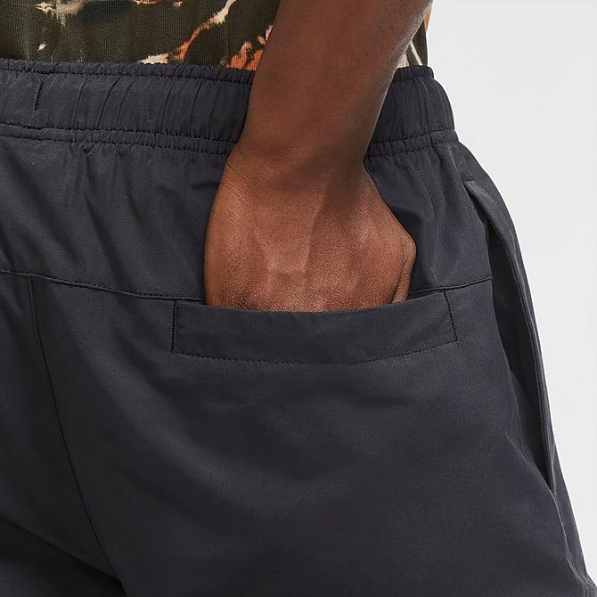 On Model 5 view of Men's Nike Sportswear Cargo Sweatpants in Black/White Click to zoom