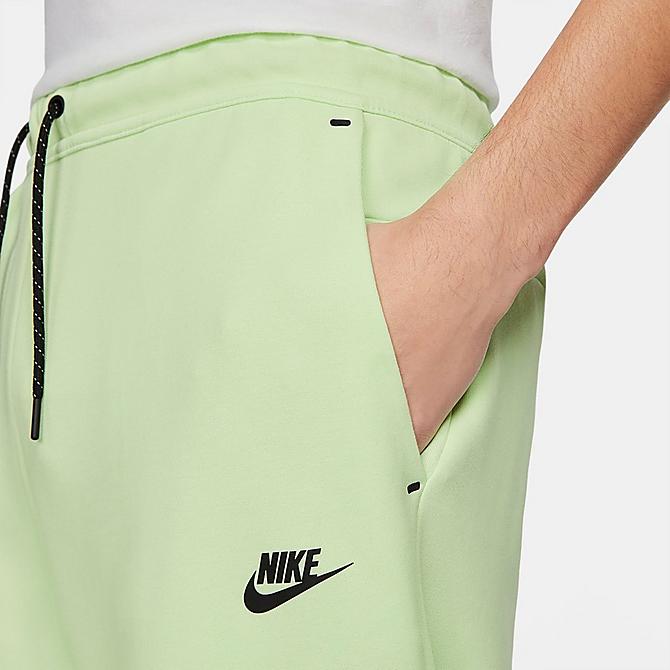 On Model 5 view of Nike Tech Fleece Taped Jogger Pants in Light Liquid Lime/Black Click to zoom