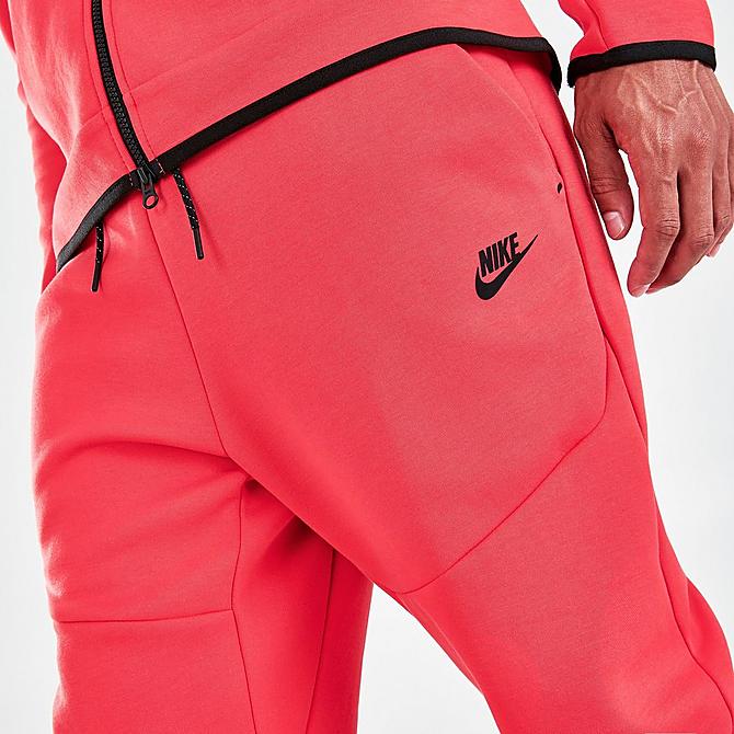On Model 6 view of Nike Tech Fleece Taped Jogger Pants in Lobster/Black Click to zoom