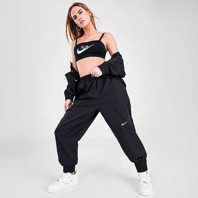 Front Three Quarter view of Women's Nike Sportswear Swoosh Woven Jogger Pants in Black Click to zoom