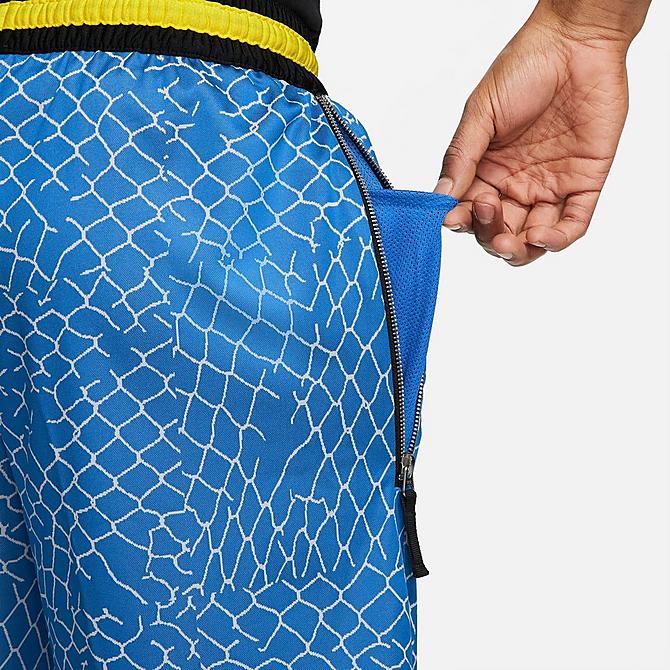 On Model 6 view of Men's Nike DNA Seasonal Graphic Basketball Shorts in Signal Blue/Light Smoke Grey/Black Click to zoom