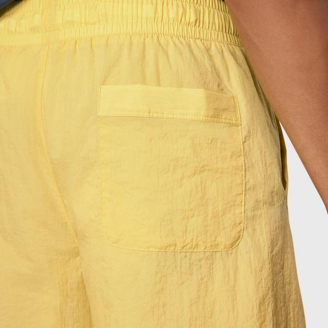 On Model 5 view of Men's Nike Sportswear Alumni Woven Shorts in Saturn Gold Click to zoom