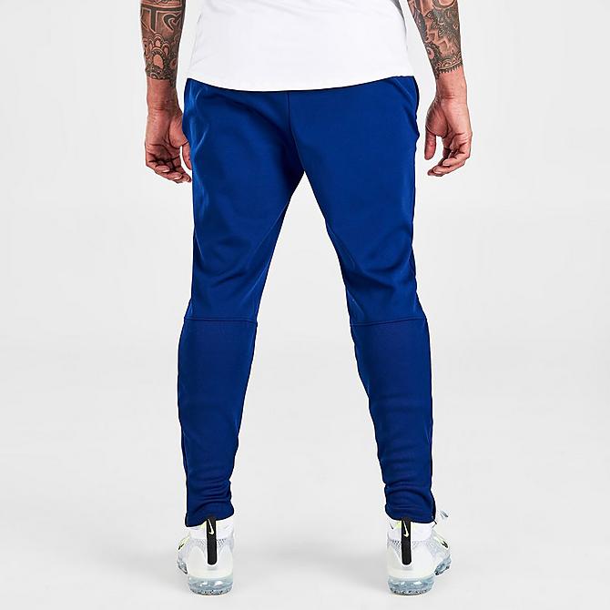 Back Right view of Men's Nike Therma-FIT Academy Winter Warrior Soccer Training Pants in Blue Void/Volt Click to zoom