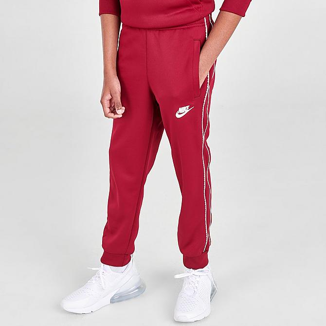 Front Three Quarter view of Kids' Nike Futura Repeat Tape Jogger Pants in Team Red/White Click to zoom