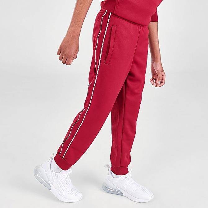Back Left view of Kids' Nike Futura Repeat Tape Jogger Pants in Team Red/White Click to zoom