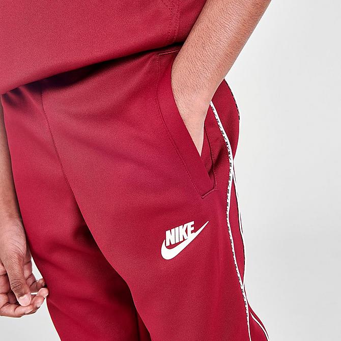 On Model 5 view of Kids' Nike Futura Repeat Tape Jogger Pants in Team Red/White Click to zoom