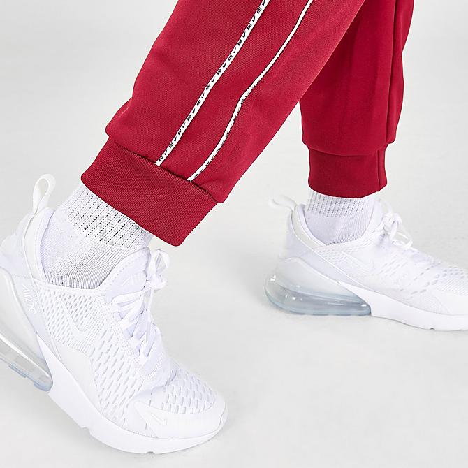 On Model 6 view of Kids' Nike Futura Repeat Tape Jogger Pants in Team Red/White Click to zoom
