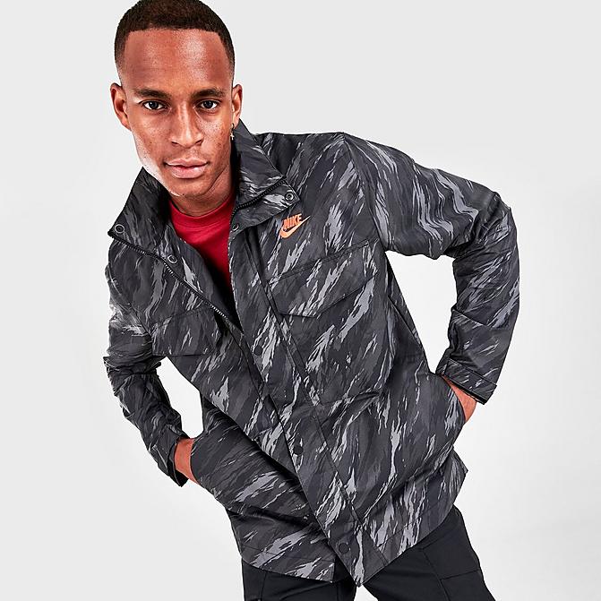 Front view of Men's Nike Sportswear Essentials+ Unlined M65 Allover Print Jacket in Black/Orange Click to zoom