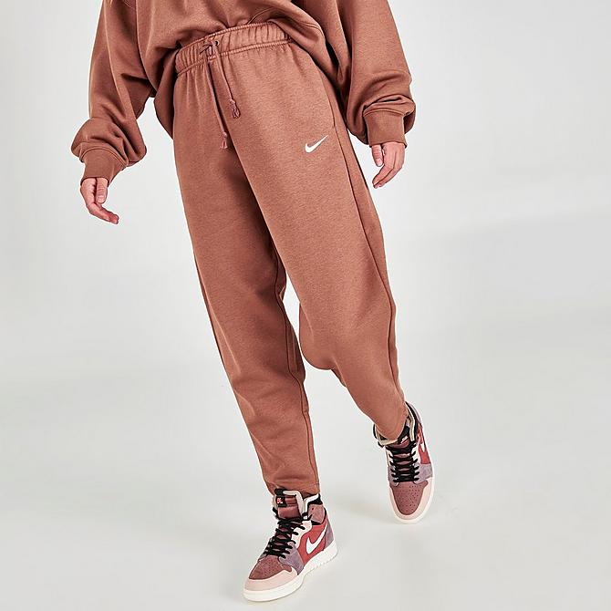 Front Three Quarter view of Women's Nike Sportswear Collection Essentials Curve Fleece Jogger Pants in Archaeo Brown/White Click to zoom