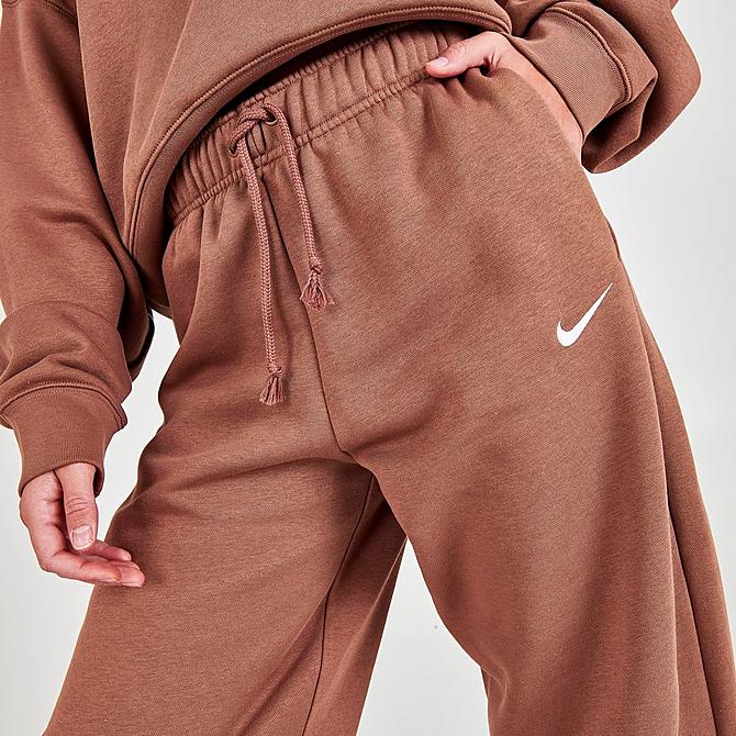 On Model 5 view of Women's Nike Sportswear Collection Essentials Curve Fleece Jogger Pants in Archaeo Brown/White Click to zoom