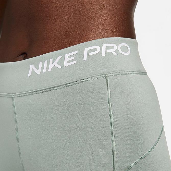 On Model 5 view of Women's Nike Pro Therma-FIT Mid-Rise Pocket Leggings in Jade Smoke/White Click to zoom