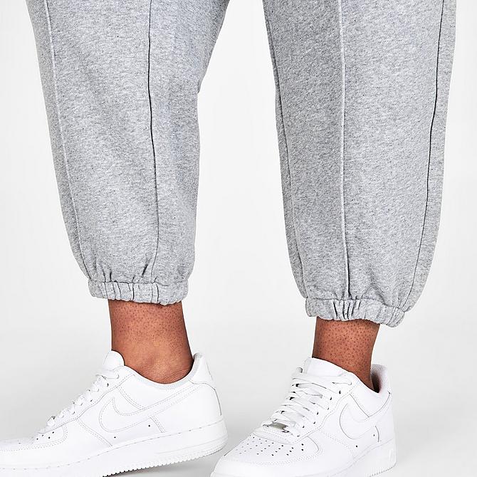 On Model 6 view of Women's Nike Sportswear Essential Fleece Jogger Pants (Plus Size) in Dark Grey Heather/White Click to zoom