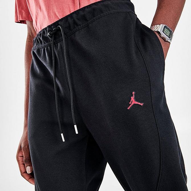 On Model 5 view of Men's Jordan Essentials Warmup Pants in Black/Gym Red Click to zoom