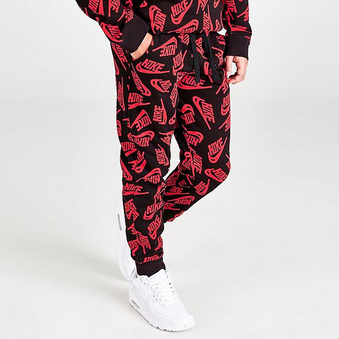 Back Left view of Kids' Nike Sportswear Allover Logo Jogger Pants in University Red/Black Click to zoom