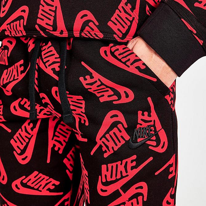 On Model 5 view of Kids' Nike Sportswear Allover Logo Jogger Pants in University Red/Black Click to zoom