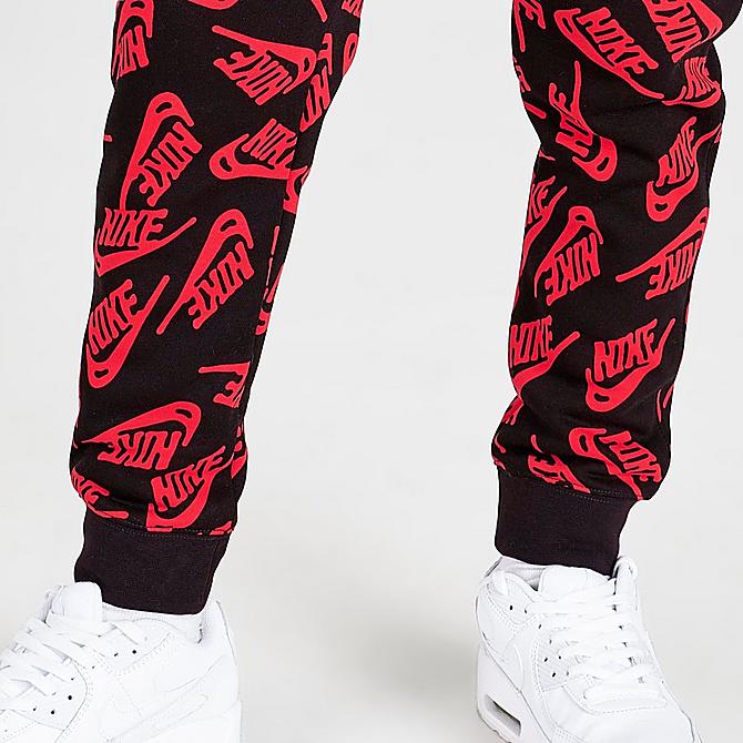 On Model 6 view of Kids' Nike Sportswear Allover Logo Jogger Pants in University Red/Black Click to zoom