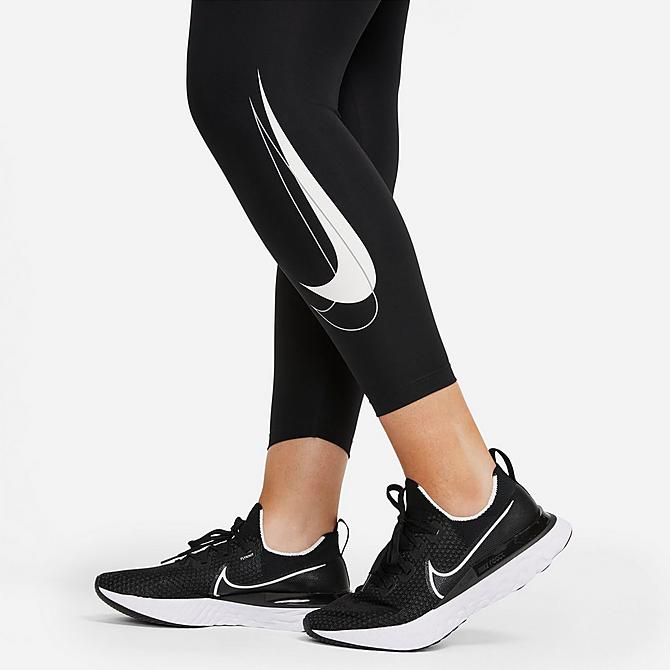 Back Right view of Women's Nike Dri-FIT Swoosh Run Mid-Rise Cropped Running Leggings (Plus Size) in Black/White Click to zoom