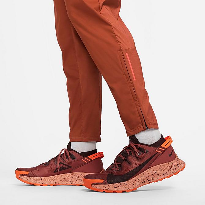On Model 5 view of Men's Nike Dri-FIT Phenom Elite Trail Running Pants in Rugged Orange/Mantra Orange/Habanero Red Click to zoom