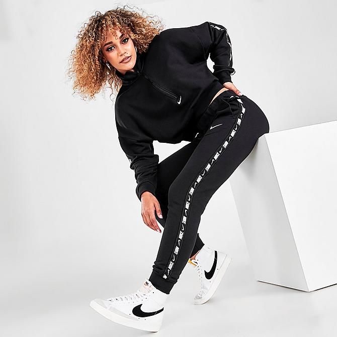 Front Three Quarter view of Women's Nike Sportswear Essential Tape Fleece Jogger Pants in Black/White Click to zoom