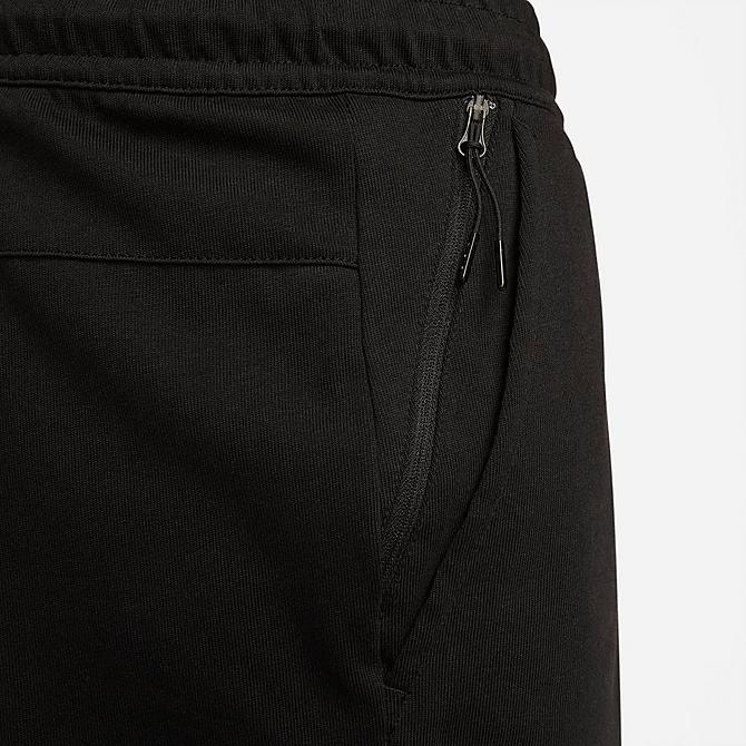 On Model 5 view of Men's Nike Sportswear Lightweight Open Hem Knit Pants in Black/Black/Black Click to zoom