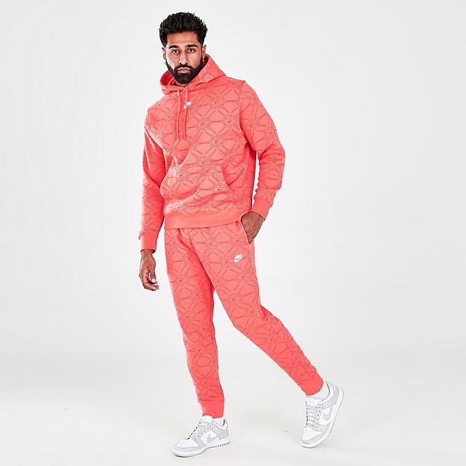 Front view of Men's Nike Sportswear Club Allover Print Jogger Pants in Magic Ember Click to zoom