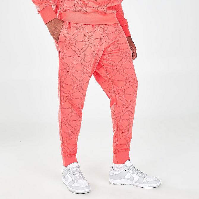 Back Left view of Men's Nike Sportswear Club Allover Print Jogger Pants in Magic Ember Click to zoom