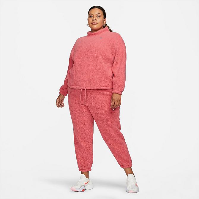 Front Three Quarter view of Women's Nike Therma-FIT Core Cozy Fleece Sweatshirt (Plus Size) in Archaeo Pink/White Click to zoom