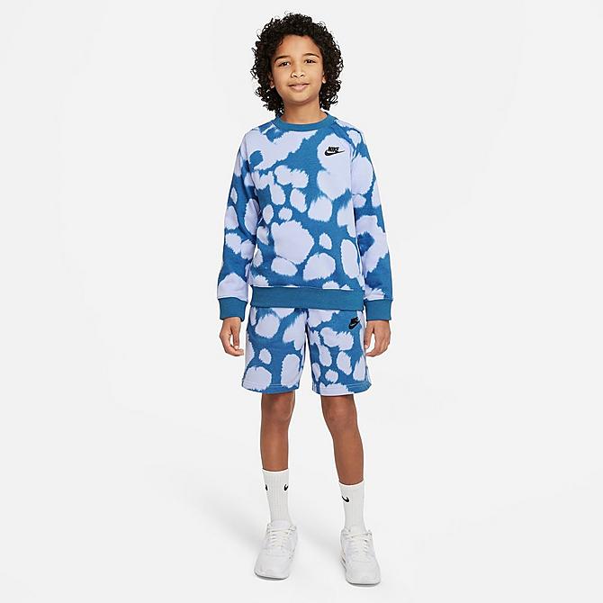 Front Three Quarter view of Boys' Nike Sportswear All-Over Print French Terry Shorts in Light Marine/Black Click to zoom