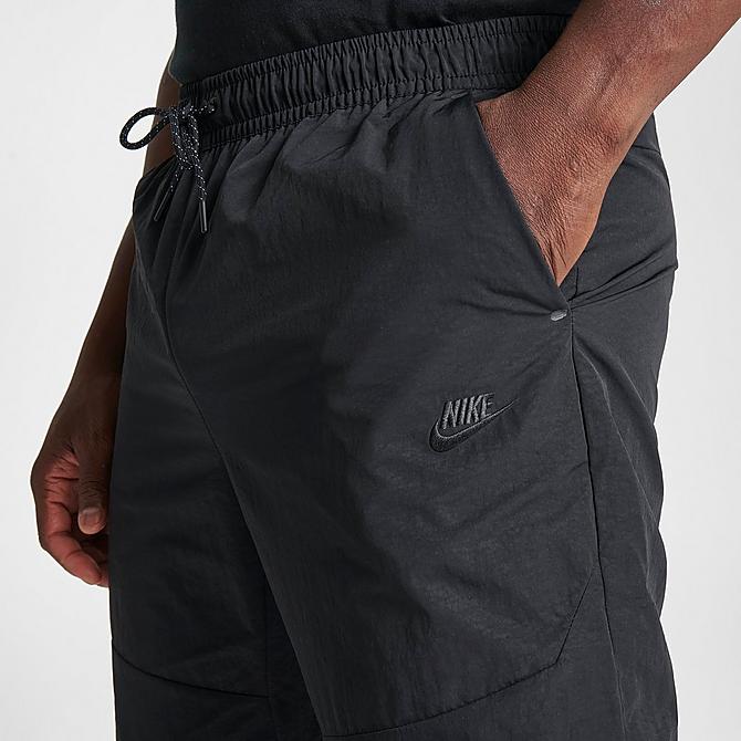 On Model 5 view of Men's Nike Sportswear Tech Essentials Lined Commuter Pants in Black/Black Click to zoom