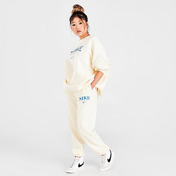 Front Three Quarter view of Women's Nike Sportswear Collection Essentials Collegiate Fleece Jogger Pants in Coconut Milk/Dutch Blue Click to zoom