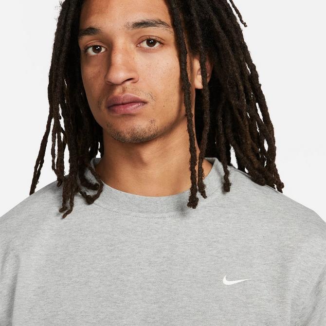 [angle] view of Men's Nike Dri-FIT Standard Issue Crewneck Sweatshirt in Dark Grey Heather/Pale Ivory Click to zoom