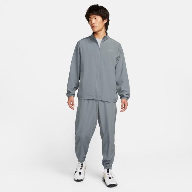 [angle] view of Men's Nike Form Dri-FIT Tapered Versatile Pants in Smoke Grey/Black/Reflective Silver Click to zoom