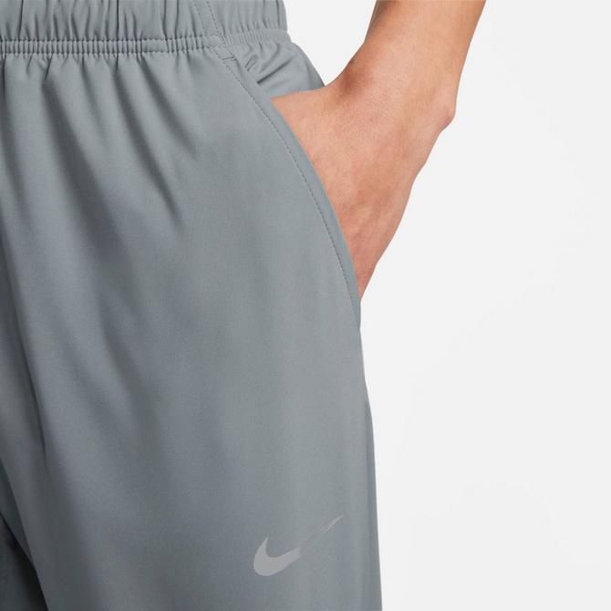 [angle] view of Men's Nike Form Dri-FIT Tapered Versatile Pants in Smoke Grey/Black/Reflective Silver Click to zoom