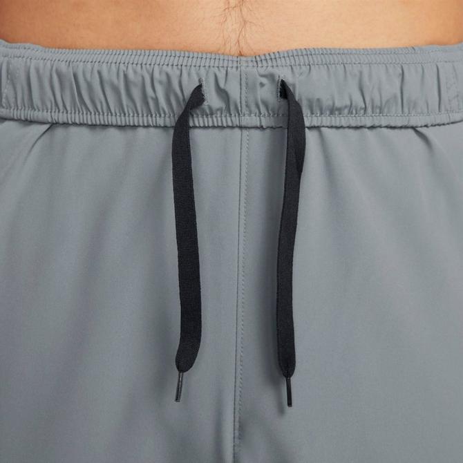[angle] view of Men's Nike Form Dri-FIT Tapered Versatile Pants in Smoke Grey/Black/Reflective Silver Click to zoom