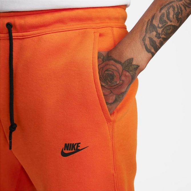 Orange best sale nike joggers